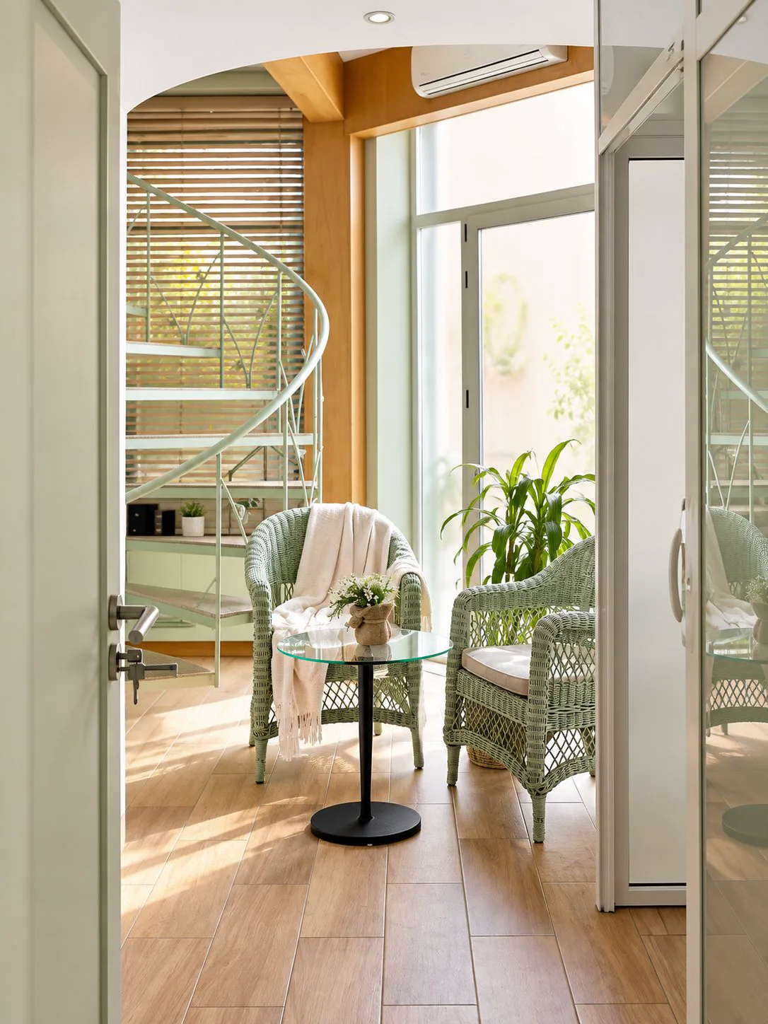 Espace détente du cabinet, fauteuils en rotin sauge et plantes